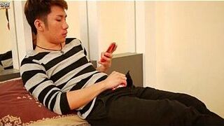 Asian gay strokes his cock in bed - porn video